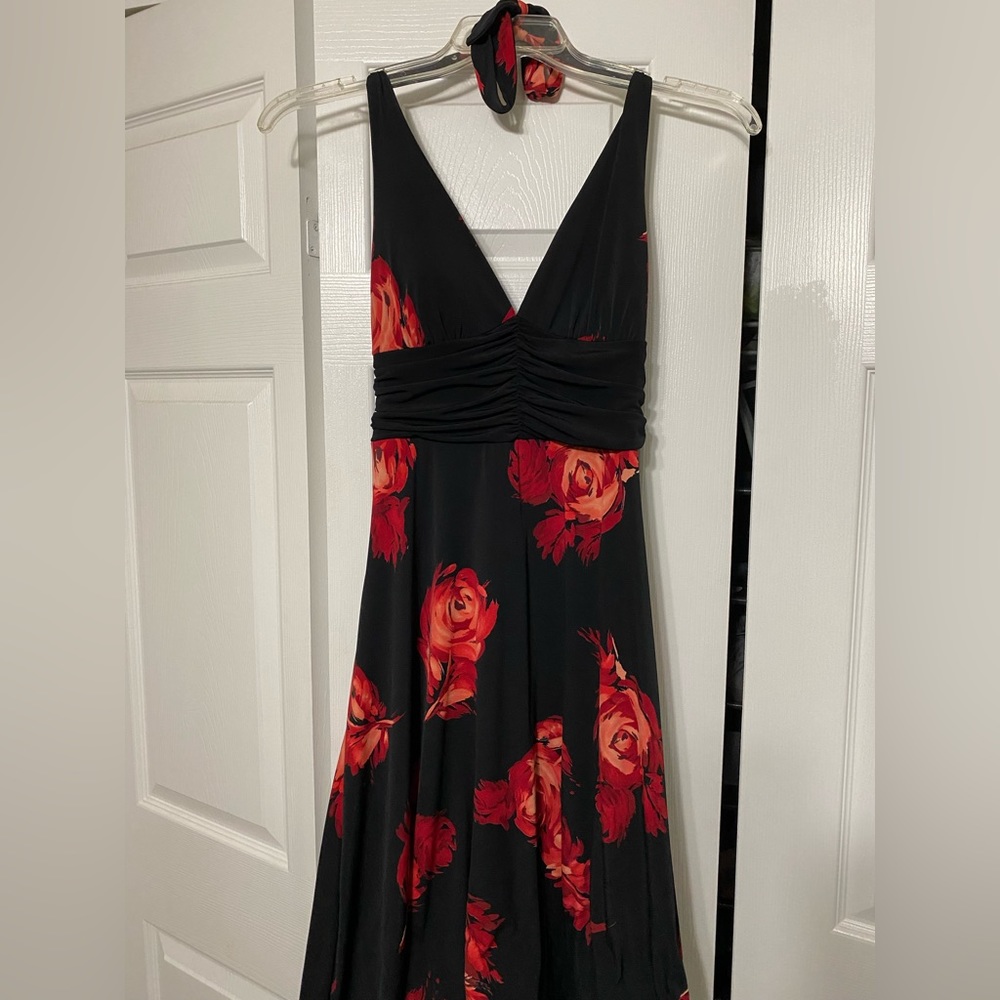 This is a black dress with red flowers by Speechless in a size large.